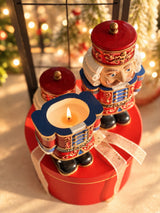 Festive red Nutcracker candle shown open and lit