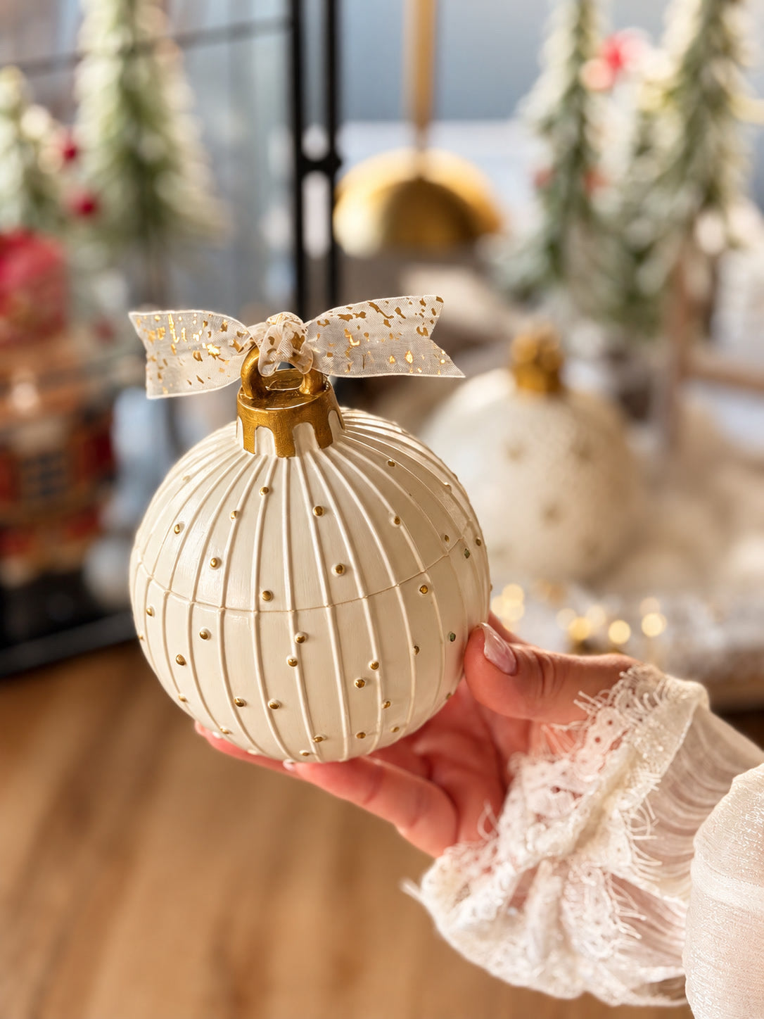 North Pole Ornament Candle with gold bow and snowy finish