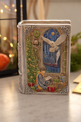 Handmade Enchanted Book Candle with an ornate fantasy cover, owl and winter scene