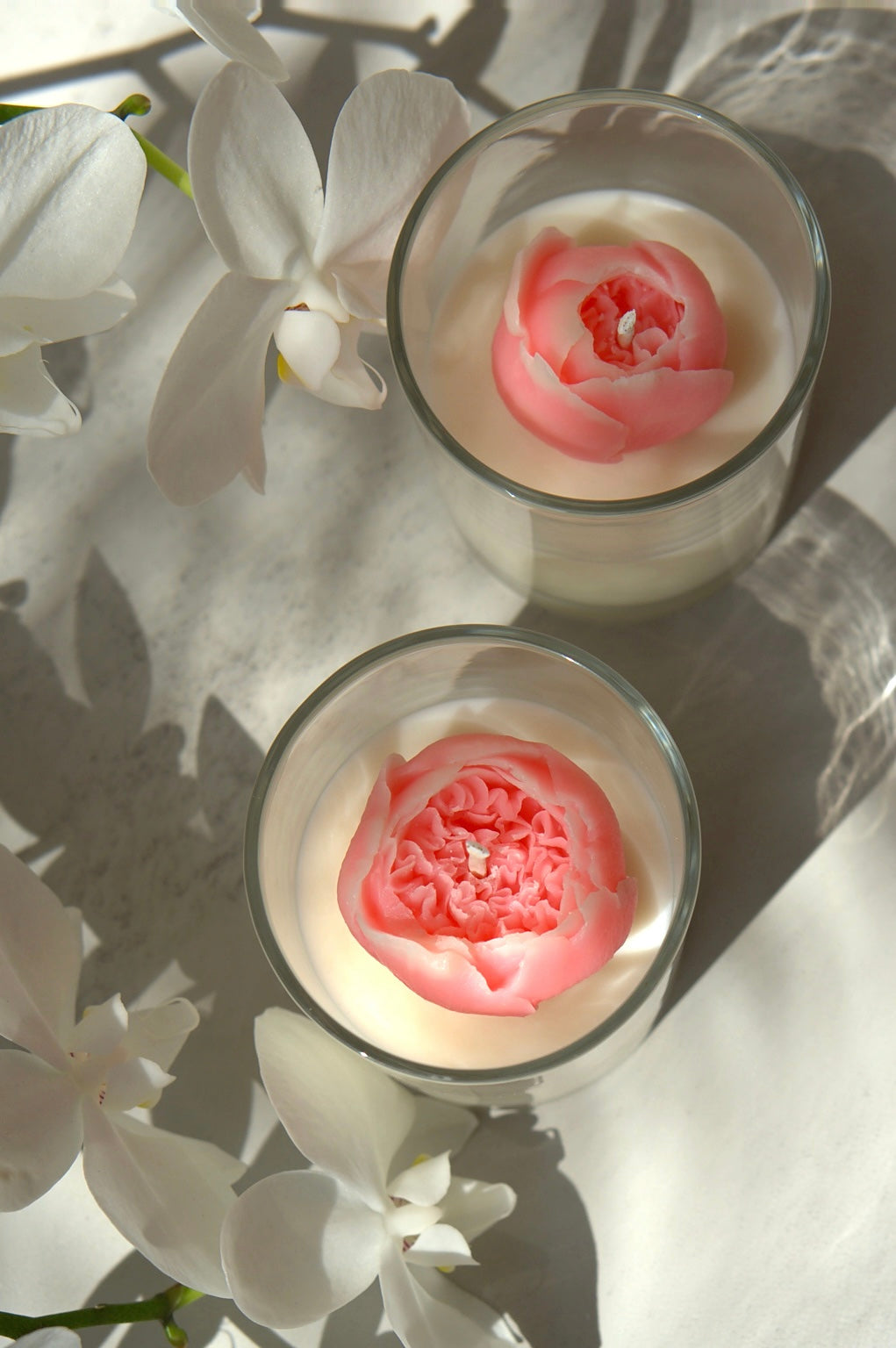 Top view of a pink 3D peony soy candle in a reusable glass jar