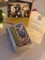 Closed Enchanted Book Candle styled with fantasy books and a keepsake letter