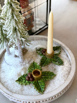 Holy Berry candle holders styled on a snowy Christmas table