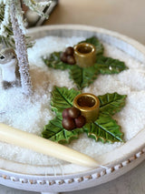 Close-up of a Holy Berry taper candle holder in a winter table setting