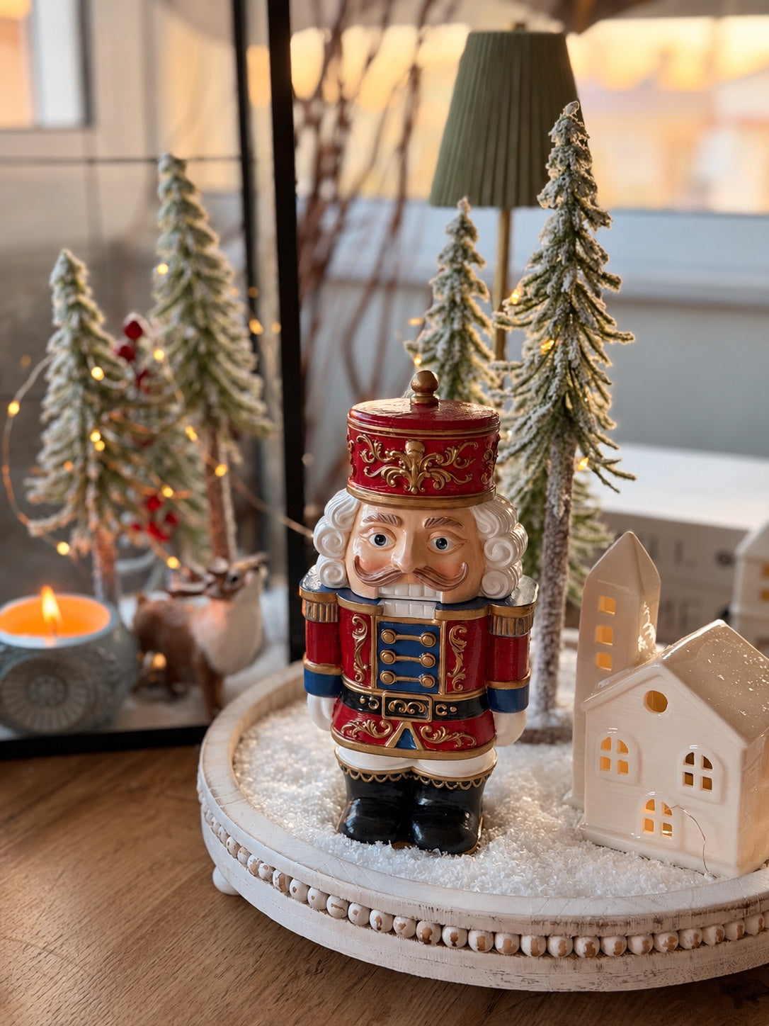 Handmade Nutcracker Candle with hand-painted red, blue, white and gold details, styled for Christmas