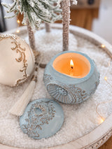 Close-up of the lit blue Romanov Secret candle and ornate lid