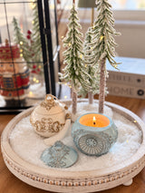 Blue and ivory Romanov Secret candles displayed together