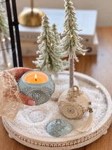 Lit blue Romanov Secret candle with decorative removable lid