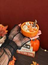 Hand holding Spooky Candle with 3D soy wax ghosts and pumpkins